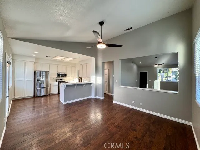 a view of kitchen with refrigerator and window