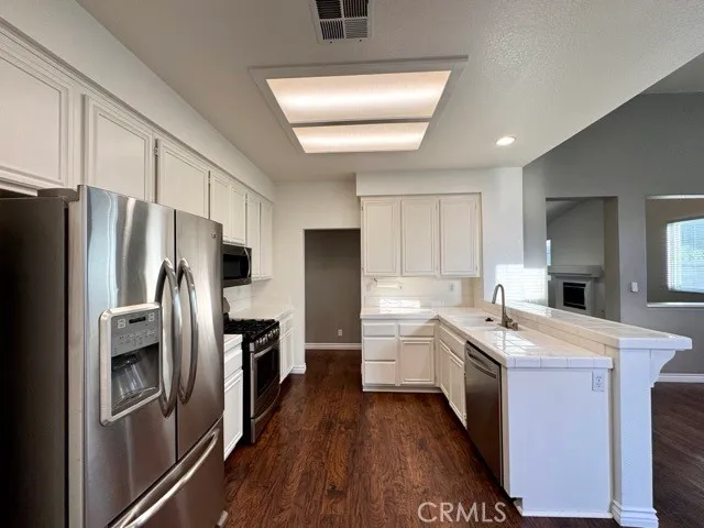a kitchen with a refrigerator sink and stove