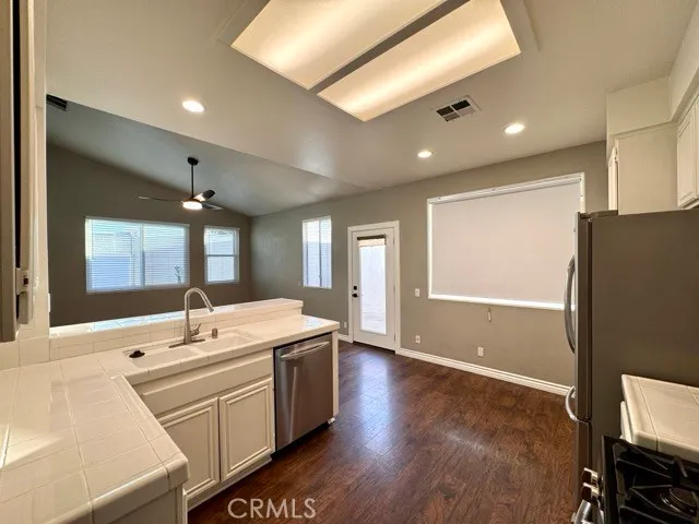 a room with a sink wooden floor and furniture