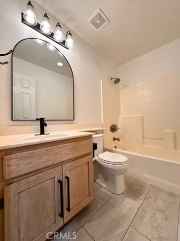 a bathroom with a double vanity sink toilet and a mirror