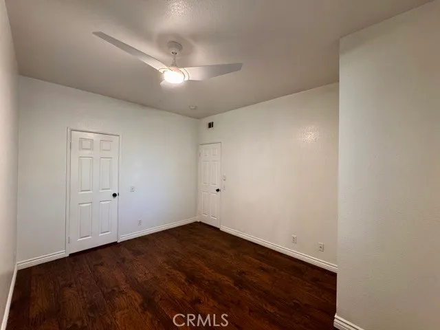 a view of a room with wooden floor