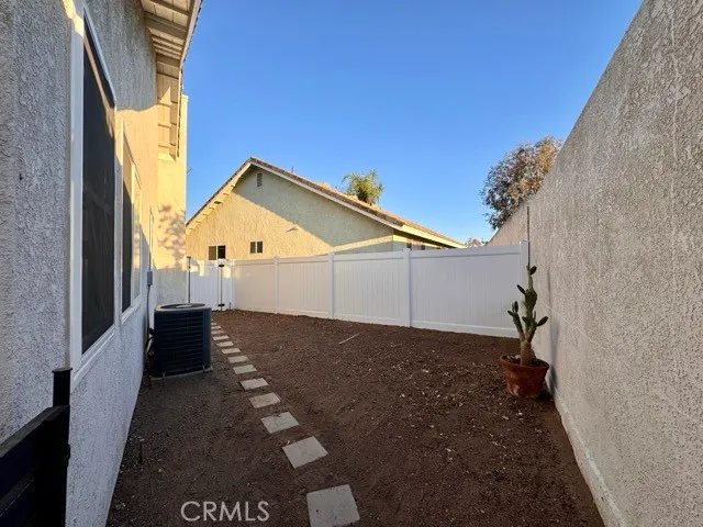 a view of a porch with furniture and a yard