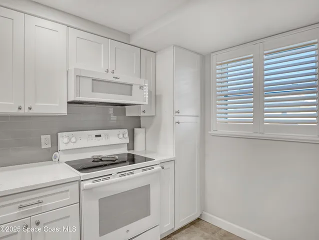 a stove top oven sitting inside of a kitchen