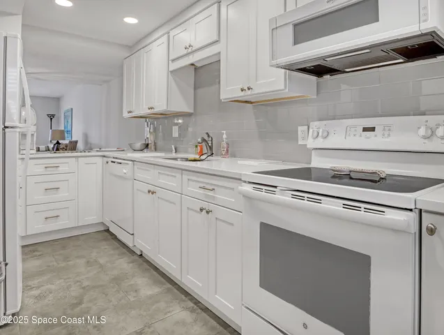 a kitchen with cabinets appliances and a sink