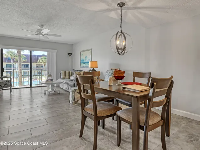 a view of a dining room with furniture wooden floor and chandelier