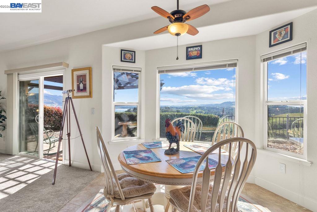 1105 Paradise Peak Road Valley Springs, CA 95252 - Photo 14 of 52 a dining room with furniture a flat screen tv and a large window