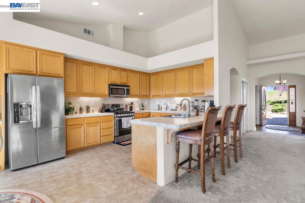 1105 Paradise Peak Road Valley Springs, CA 95252 - Photo 17 of 52 a kitchen with appliances a sink a counter top space and cabinets