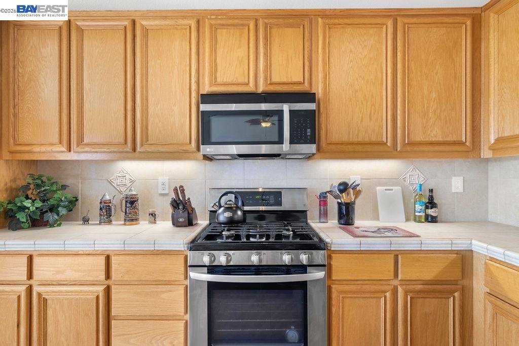 1105 Paradise Peak Road Valley Springs, CA 95252 - Photo 19 of 52 a kitchen with granite countertop cabinets stainless steel appliances a sink and a window