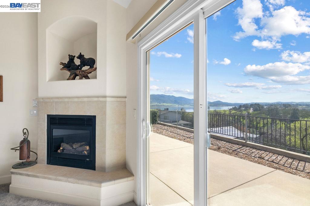 1105 Paradise Peak Road Valley Springs, CA 95252 - Photo 33 of 52 a living room with a fireplace and a floor to ceiling window