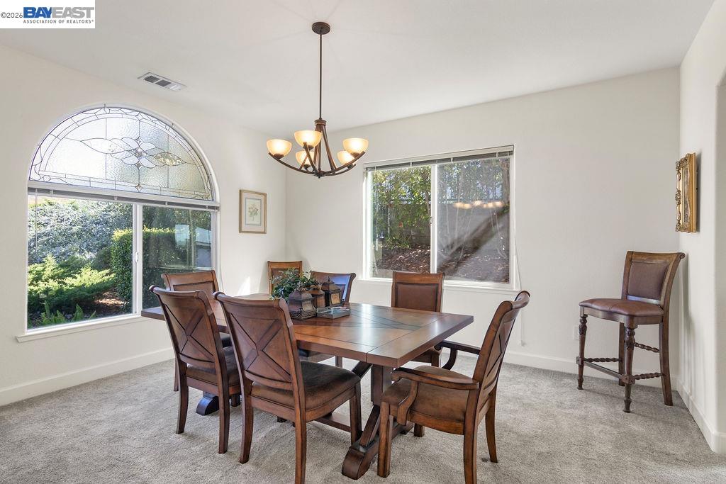 1105 Paradise Peak Road Valley Springs, CA 95252 - Photo 6 of 52 a view of a dining room with furniture a chandelier and wooden floor