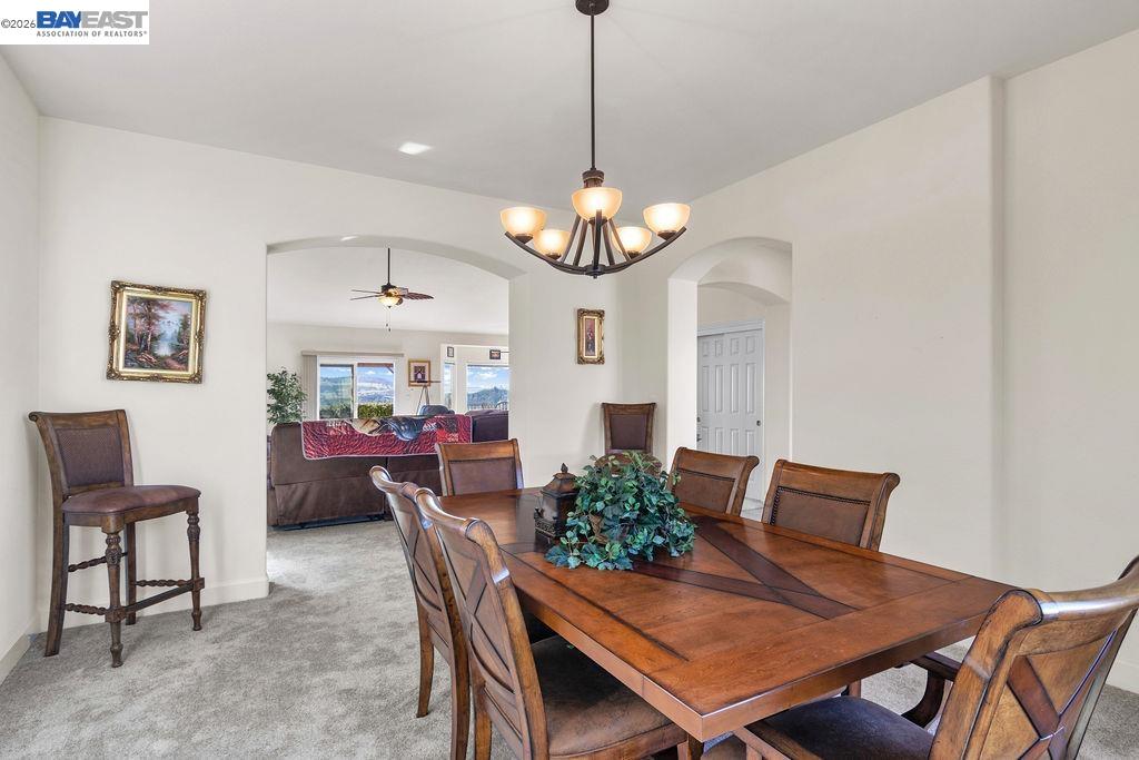 1105 Paradise Peak Road Valley Springs, CA 95252 - Photo 7 of 52 a view of a dining room with furniture and a chandelier