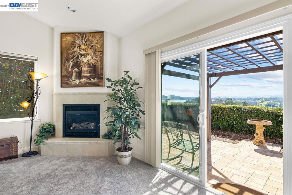 1105 Paradise Peak Road Valley Springs, CA 95252 - Photo 10 of 52 a view of a living room and a floor to ceiling window and a fireplace