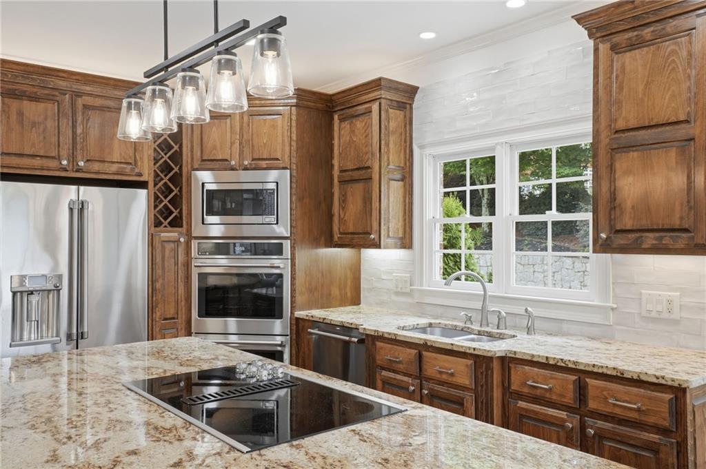 2950 Callie Still Road Lawrenceville, GA 30045 - Photo 15 of 77 a kitchen with stainless steel appliances granite countertop a sink stove and refrigerator