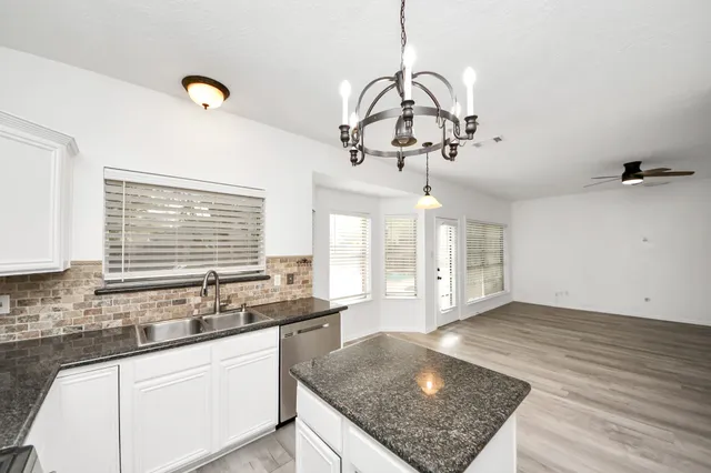 a kitchen with a sink a counter space and appliances