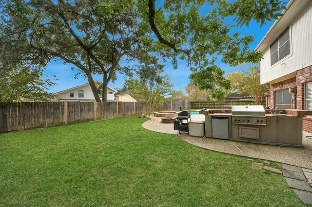 a view of a backyard with a garden and trees
