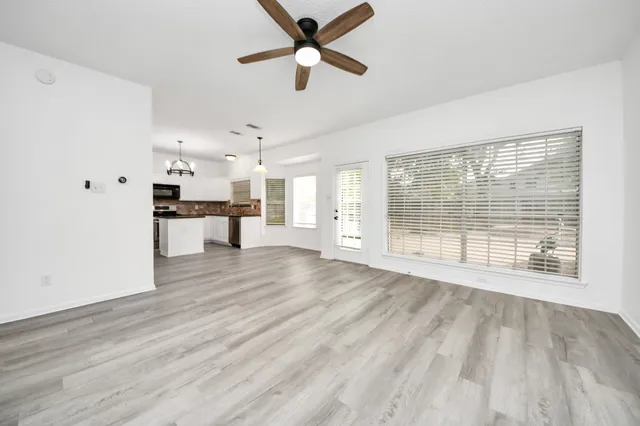 a view of a kitchen with a sink and a window