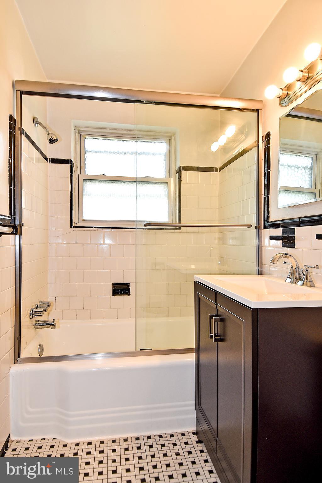 7036 Strathmore Street, Unit 311 Chevy Chase, MD 20815 - Photo 7 of 27 a bathroom with a sink and a bathtub