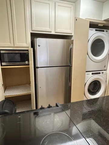 a close view of a stove sink and cabinets
