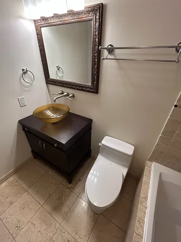 a white bath tub sitting next to a toilet
