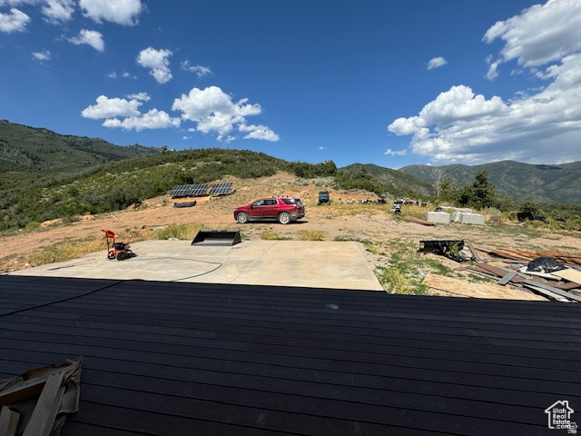 6909 East Spring Drive, Unit 19 Springville, UT 84663 - Photo 34 of 118 Expansive exterior lot featuring a large concrete pad, multiple solar panel arrays on the hillside, and a broad mountain backdrop