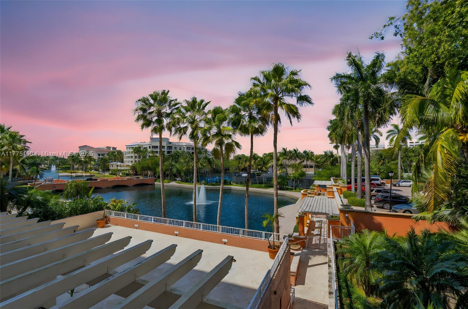 765 Crandon Boulevard, Unit 202 Key Biscayne, FL 33149 - Photo 1 of 41 a view of a lake with a deck and a garden