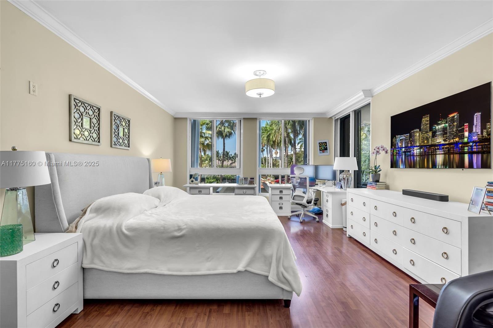 765 Crandon Boulevard, Unit 202 Key Biscayne, FL 33149 - Photo 11 of 41 a bedroom with a bed window with table and chairs