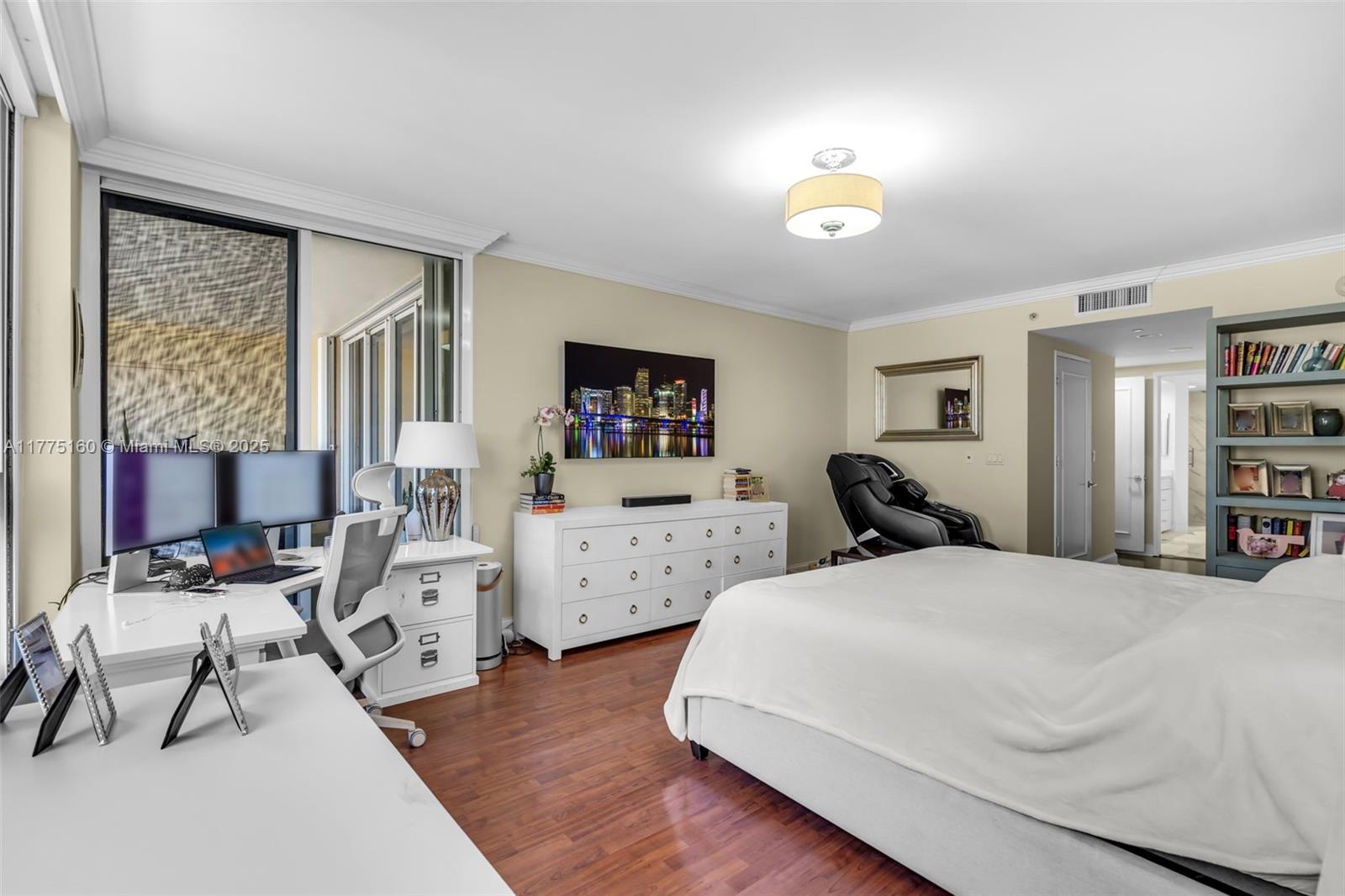 765 Crandon Boulevard, Unit 202 Key Biscayne, FL 33149 - Photo 12 of 41 a bedroom with furniture and a chandelier