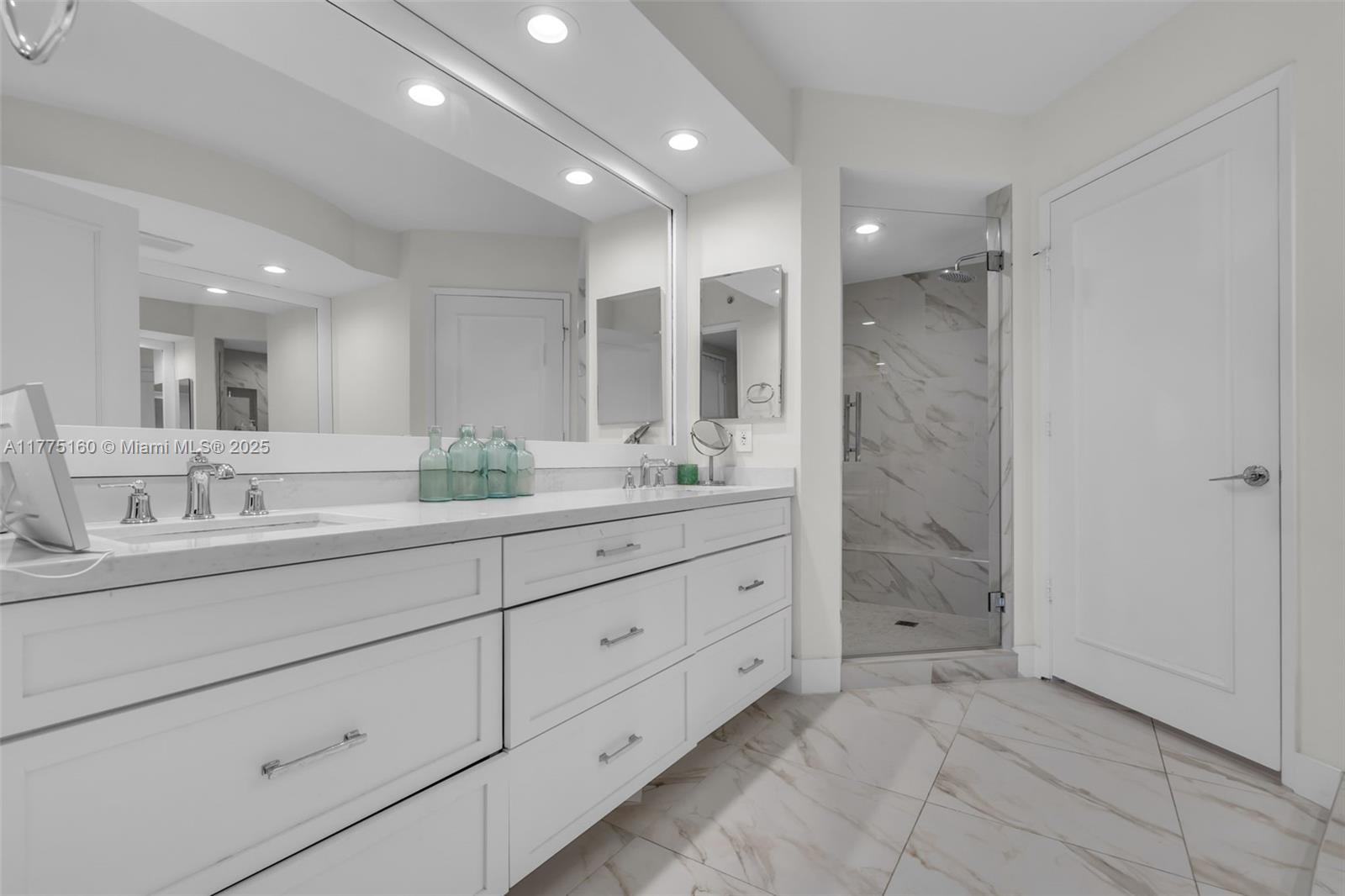 765 Crandon Boulevard, Unit 202 Key Biscayne, FL 33149 - Photo 13 of 41 a bathroom with a double vanity sink mirror and double