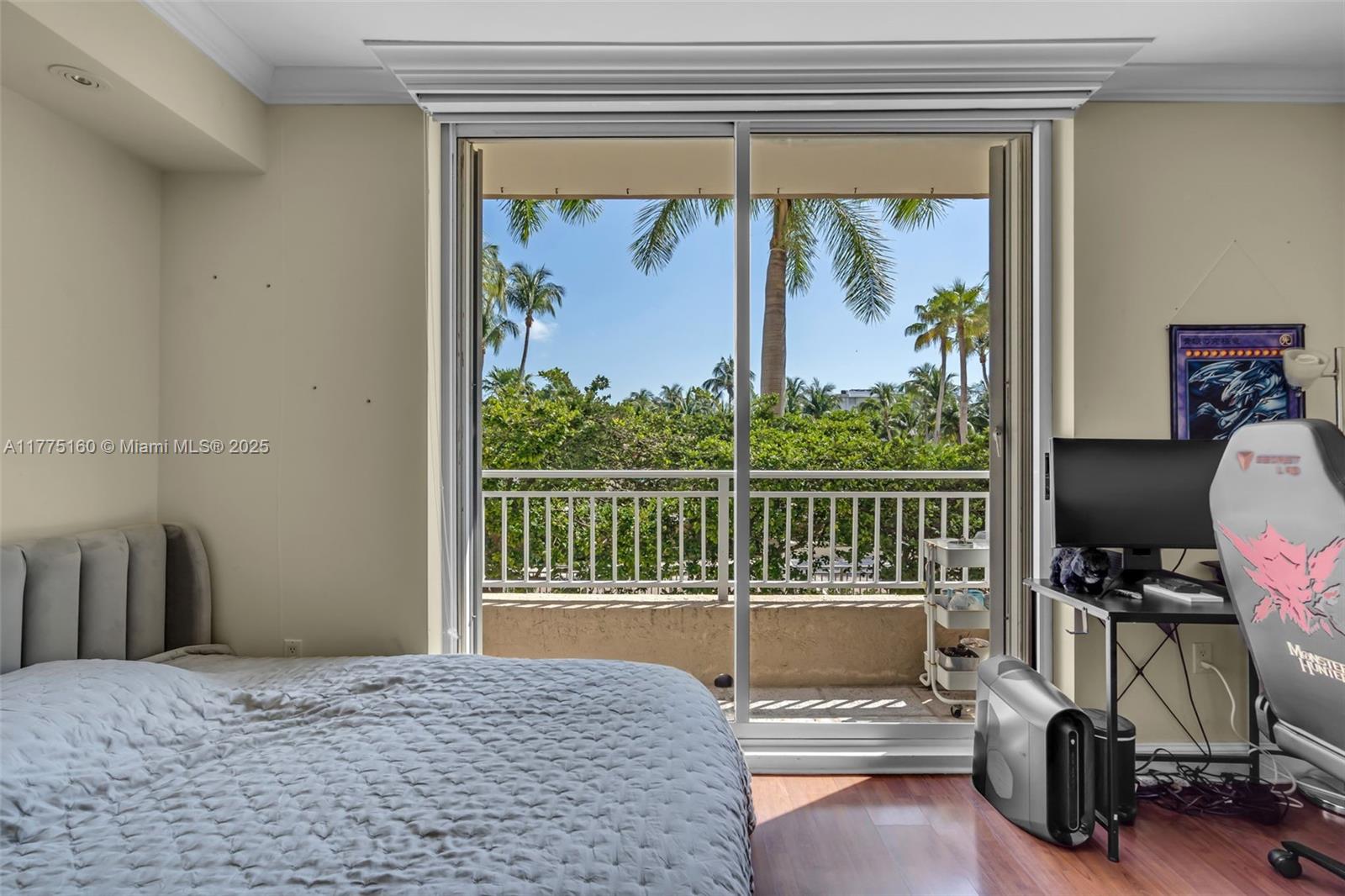765 Crandon Boulevard, Unit 202 Key Biscayne, FL 33149 - Photo 16 of 41 a bedroom with a bed and a balcony view