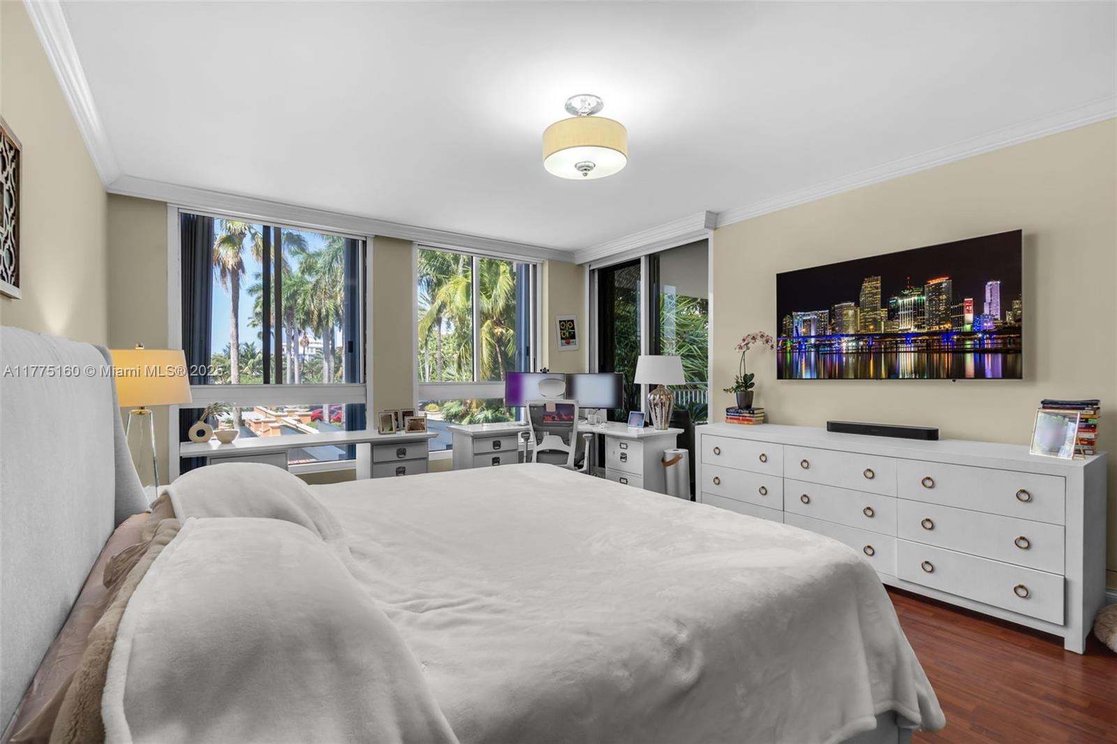 765 Crandon Boulevard, Unit 202 Key Biscayne, FL 33149 - Photo 17 of 41 a large bedroom with furniture and a flat screen tv