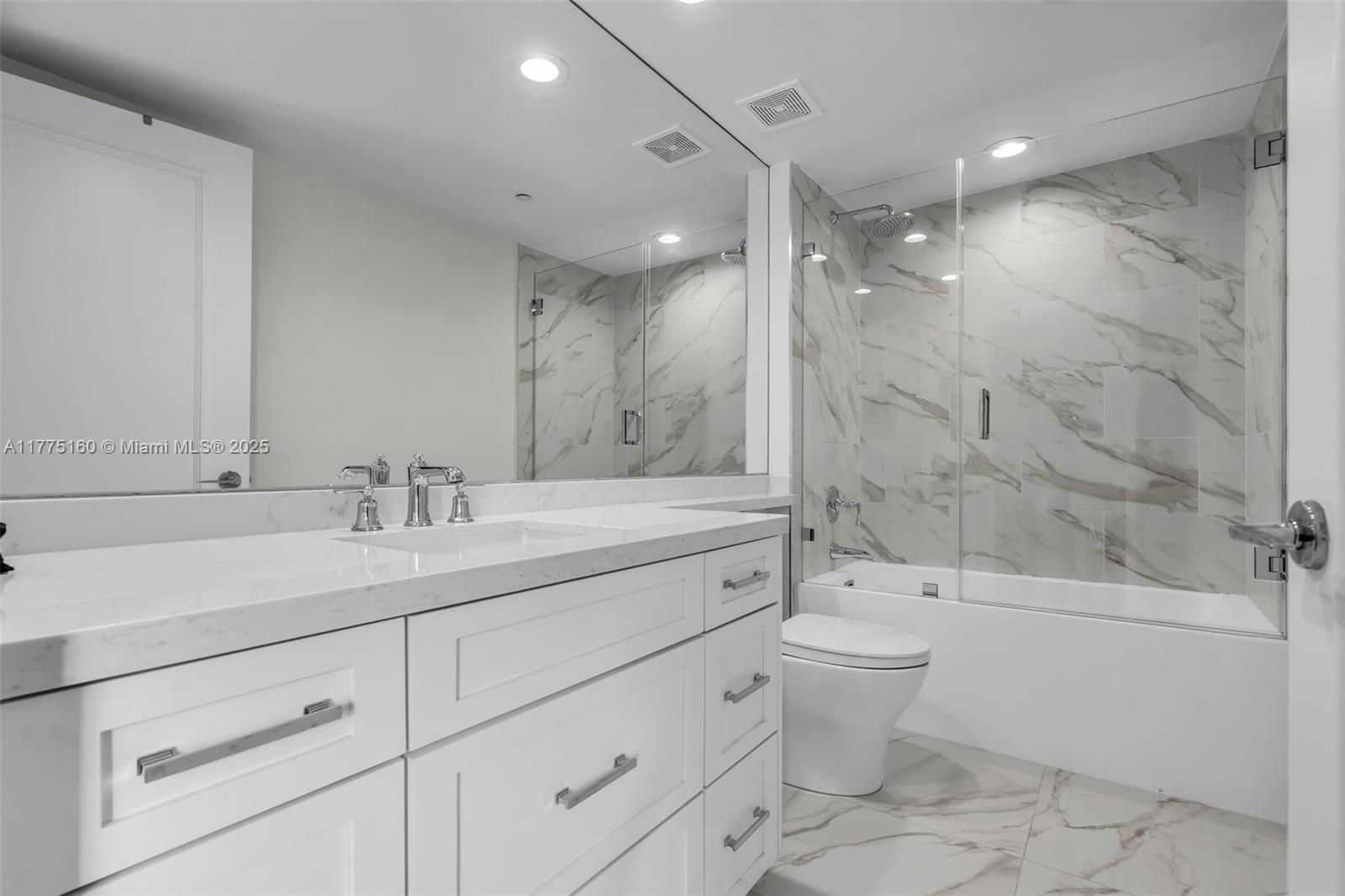 765 Crandon Boulevard, Unit 202 Key Biscayne, FL 33149 - Photo 18 of 41 a bathroom with a double vanity sink toilet and shower