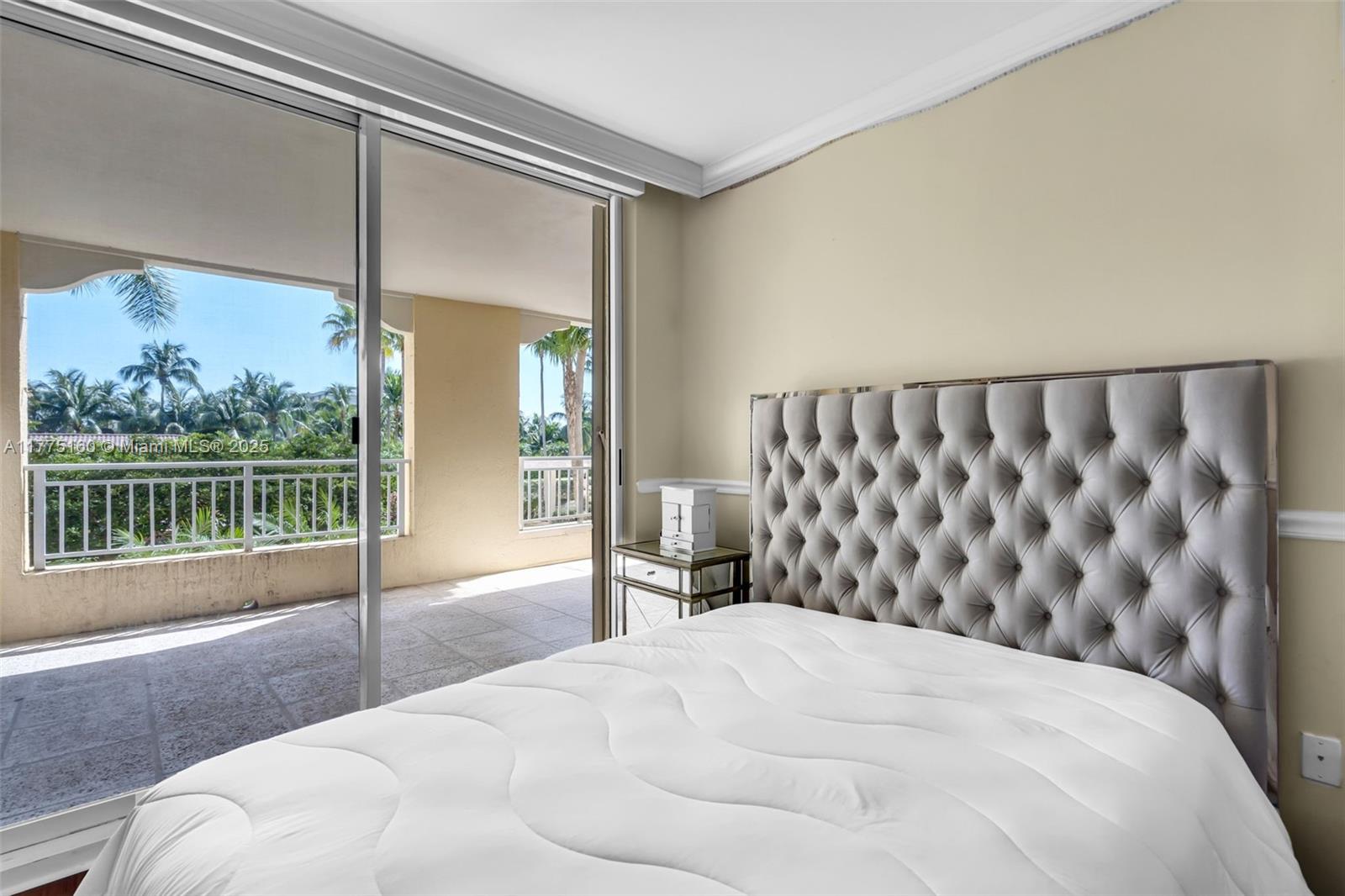765 Crandon Boulevard, Unit 202 Key Biscayne, FL 33149 - Photo 19 of 41 a bedroom with a bed and wooden floor