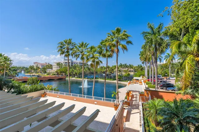 a view of a balcony with chairs and a potted plant