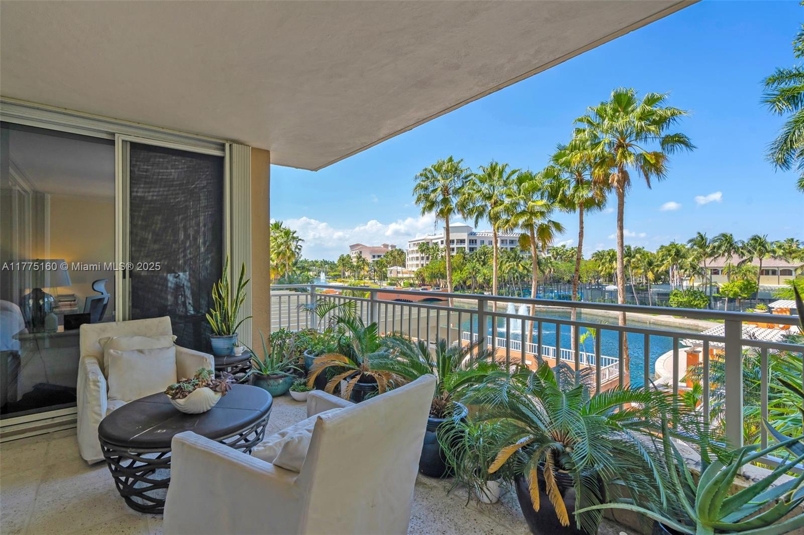 765 Crandon Boulevard, Unit 202 Key Biscayne, FL 33149 - Photo 29 of 41 a view of a balcony with chairs and a potted plant