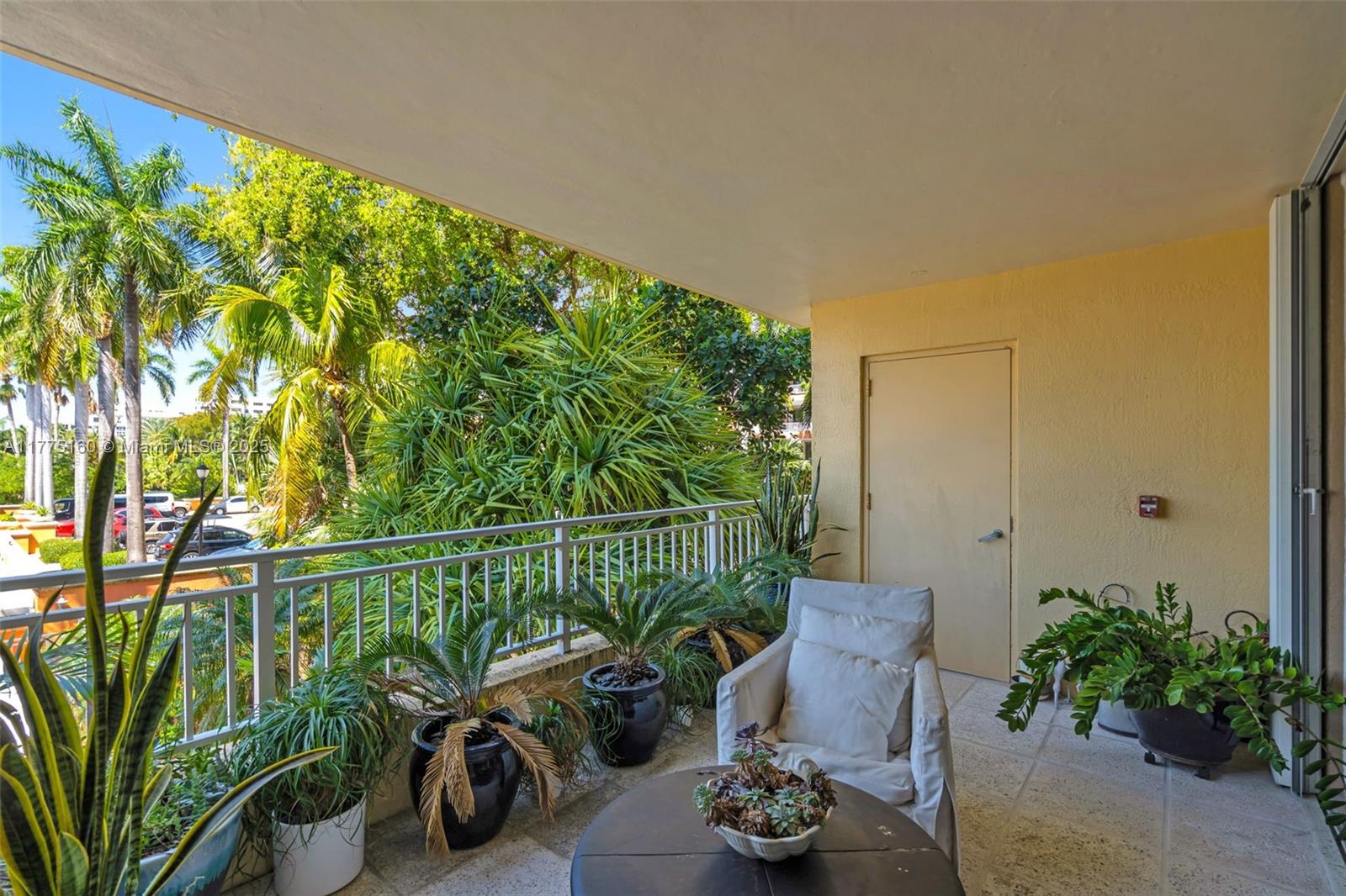 765 Crandon Boulevard, Unit 202 Key Biscayne, FL 33149 - Photo 30 of 41 a view of a balcony with chairs and potted plants