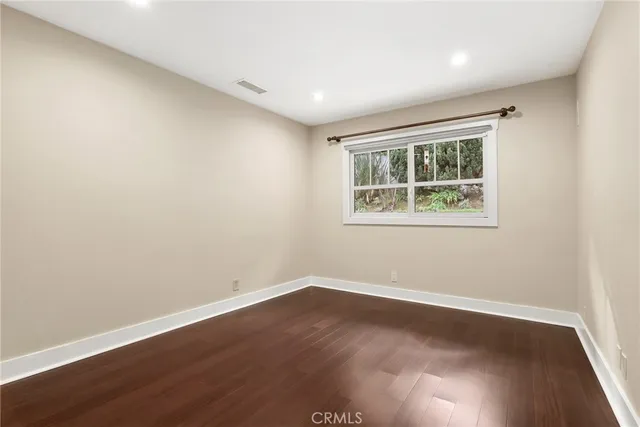 a big room with wooden floor and windows