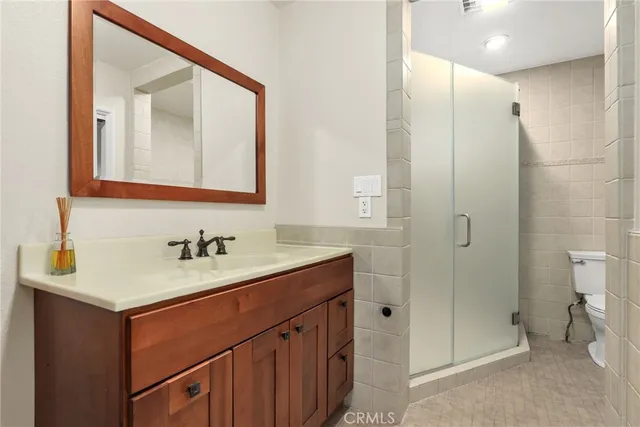 a bathroom with a sink vanity toilet and shower