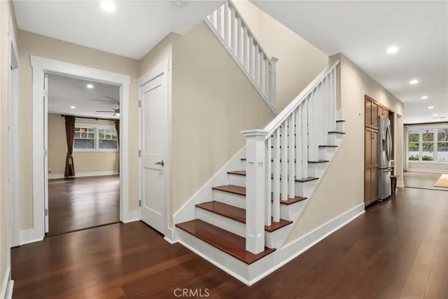 a view of entryway and hall with wooden floor