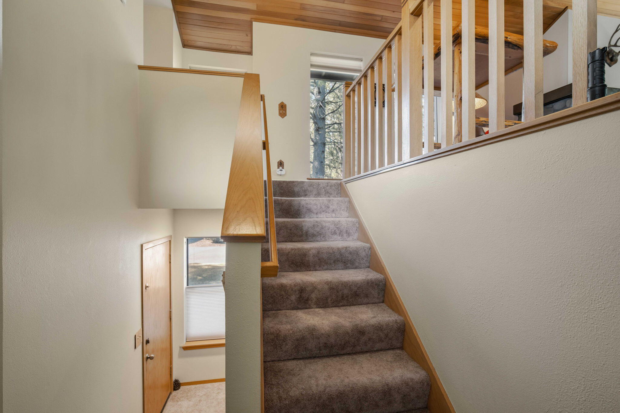 17682 Bittern Lane, Unit 31 Sunriver, OR 97707 - Photo 7 of 44 a view of staircase with lots of frames on wall and windows