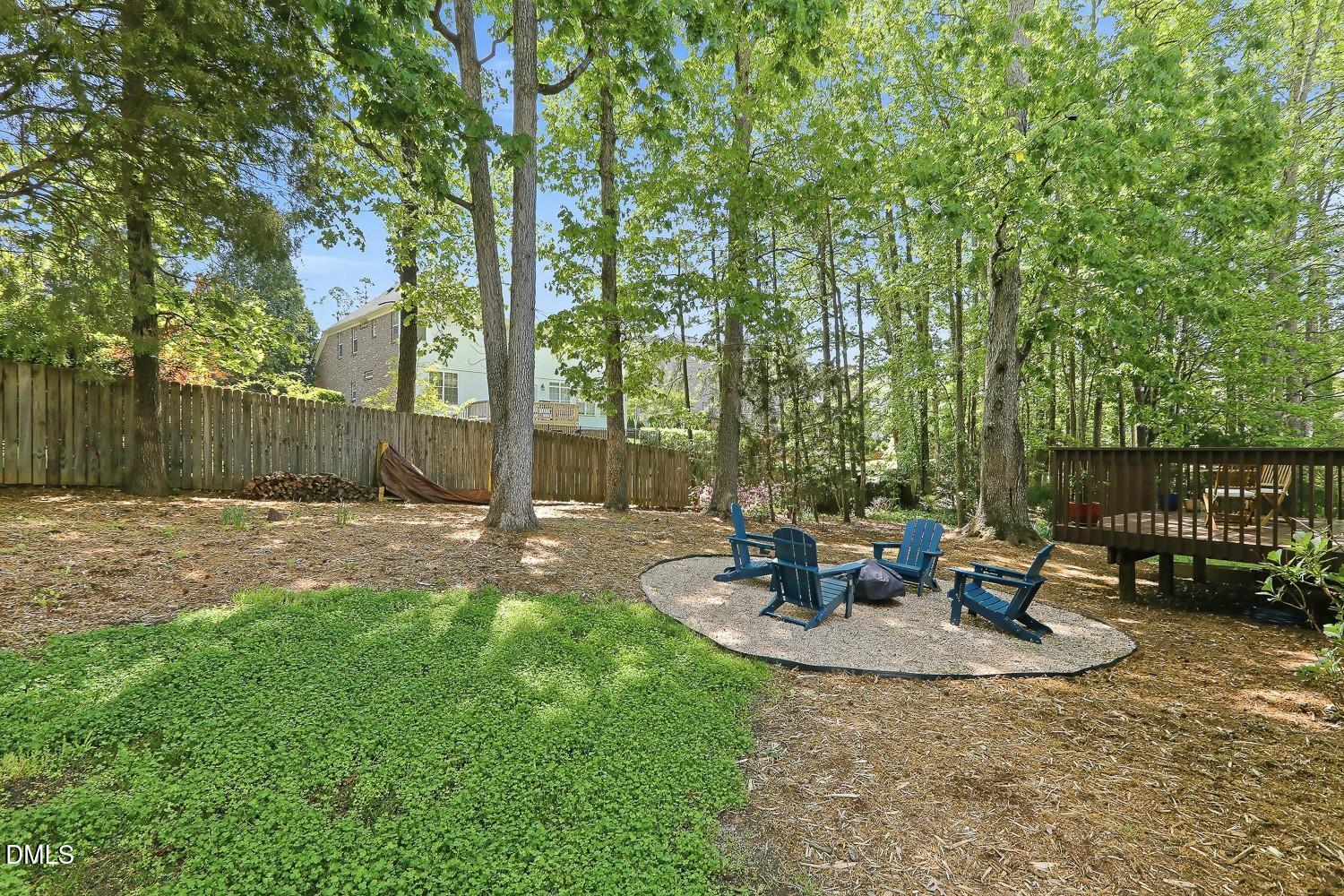 4001 Batiste Road Raleigh, NC 27613 - Photo 45 of 63 a view of a patio with table and chairs potted plants and wooden fence