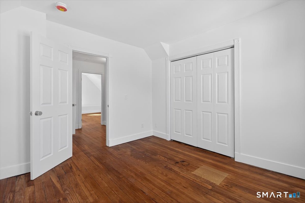 62 General Street Stratford, CT 06615 - Photo 11 of 40 an empty room with wooden floor