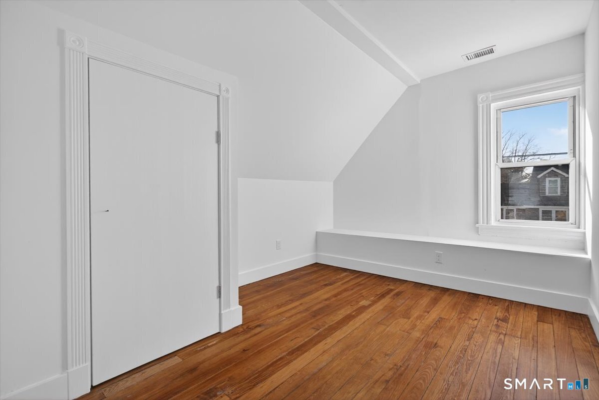 62 General Street Stratford, CT 06615 - Photo 12 of 40 a view of an empty room with wooden floor and a window