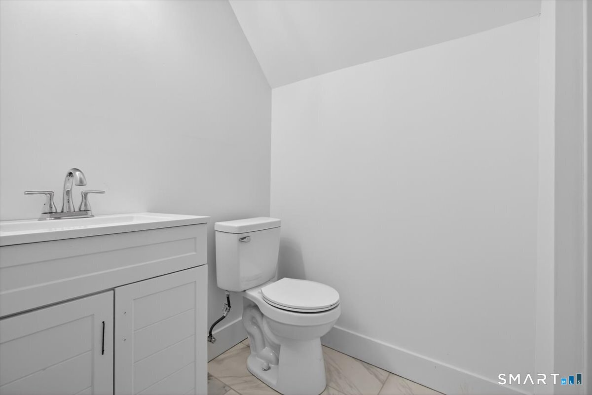 62 General Street Stratford, CT 06615 - Photo 17 of 40 a bathroom with a toilet a sink and mirror