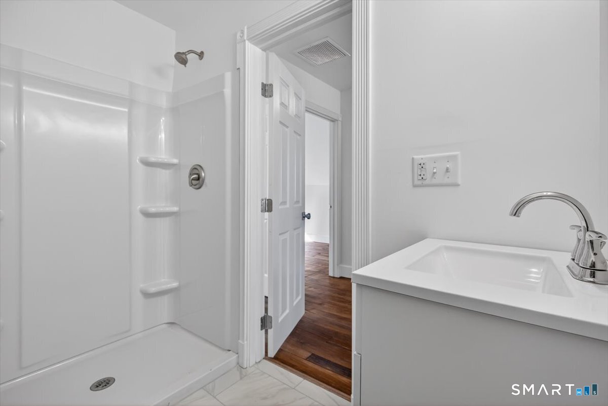 62 General Street Stratford, CT 06615 - Photo 18 of 40 a bathroom with a sink and shower