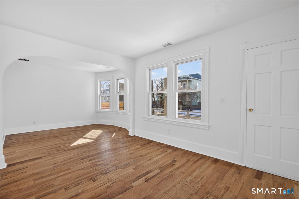 62 General Street Stratford, CT 06615 - Photo 2 of 40 a view of empty room with wooden floor and fan