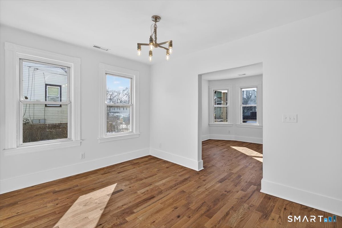 62 General Street Stratford, CT 06615 - Photo 24 of 40 a view of an empty room with wooden floor and a window