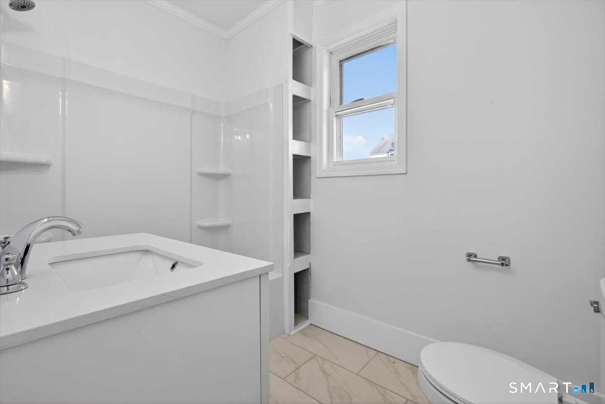 62 General Street Stratford, CT 06615 - Photo 6 of 40 a bathroom with a sink toilet and vanity
