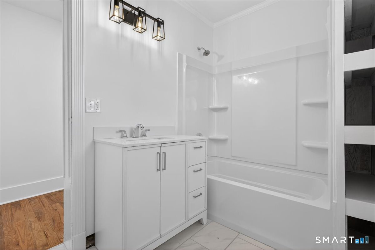 62 General Street Stratford, CT 06615 - Photo 7 of 40 a bathroom with a tub sink and mirror