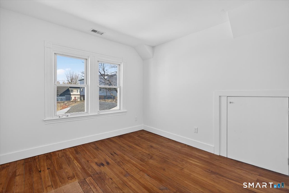 62 General Street Stratford, CT 06615 - Photo 10 of 40 a view of an empty room with wooden floor and a window
