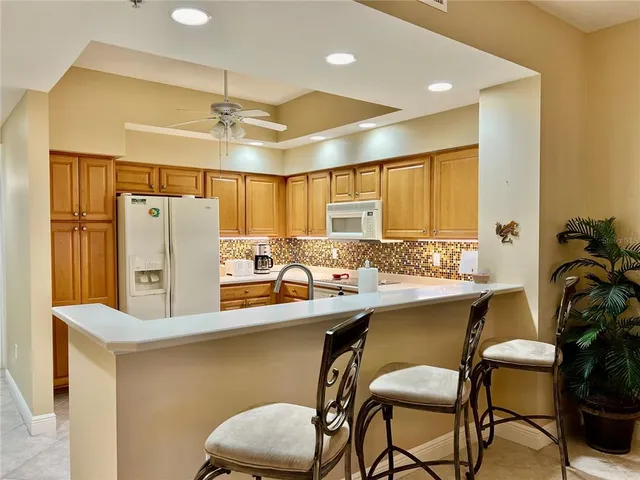 a living room with furniture a chandelier and a flat screen tv